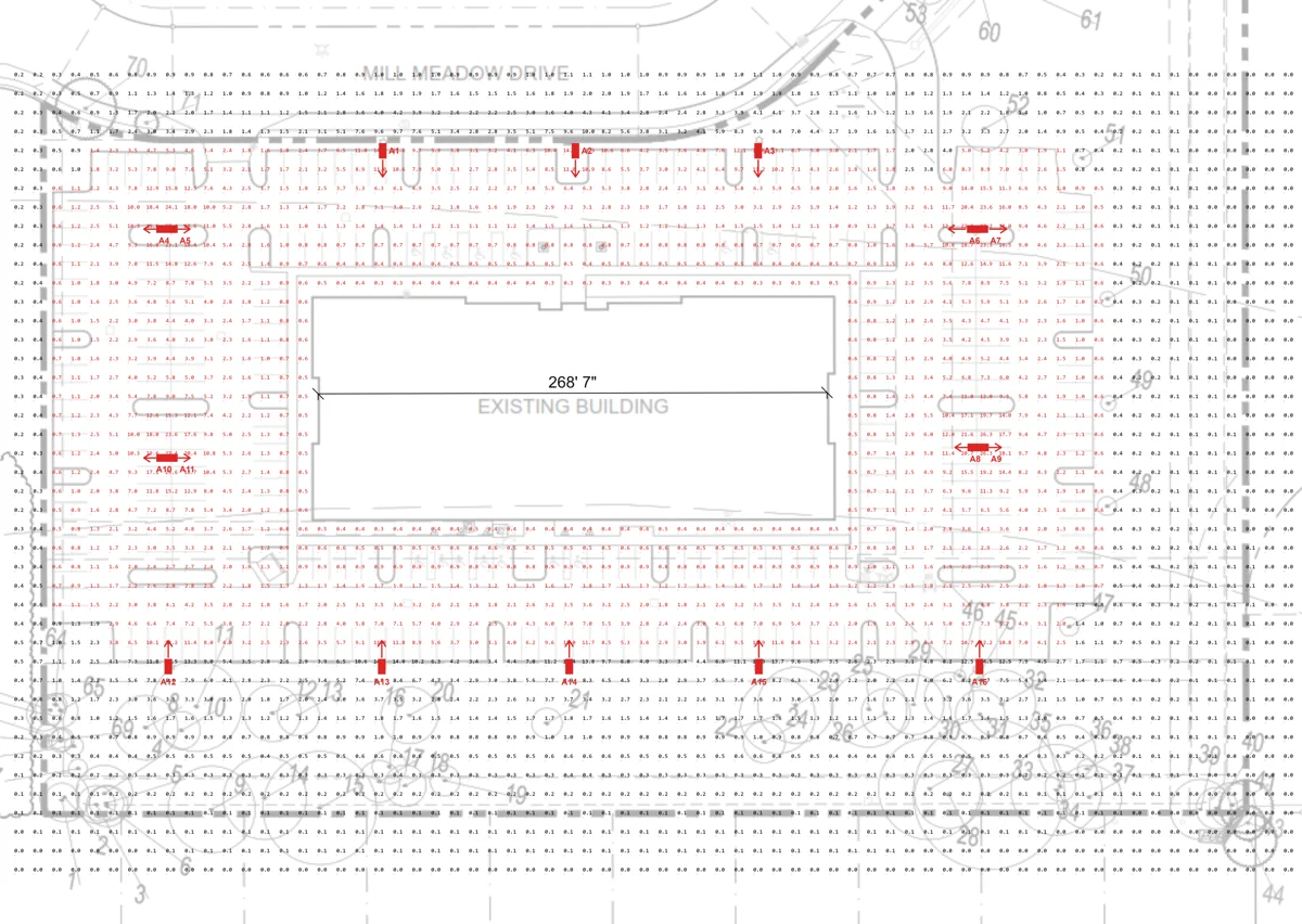 Parking lot lighting plan showing fixture positions and point-by-point foot-candle levels around an existing building